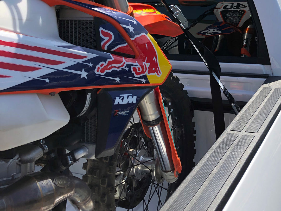 Red Bull KTM loaded in the bed of a truck.