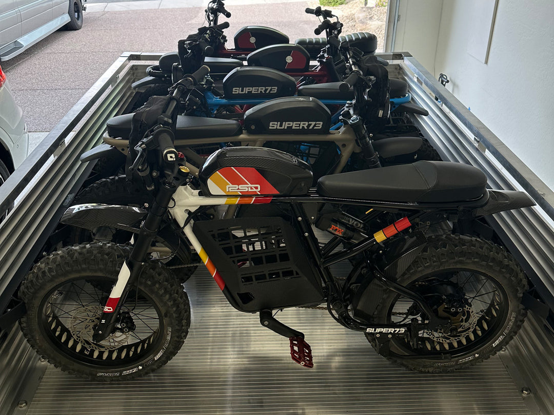 A utility trailer outfitted with the Hybrid Moto Rack system loaded with fize Super 73 eBike motorcycles.
