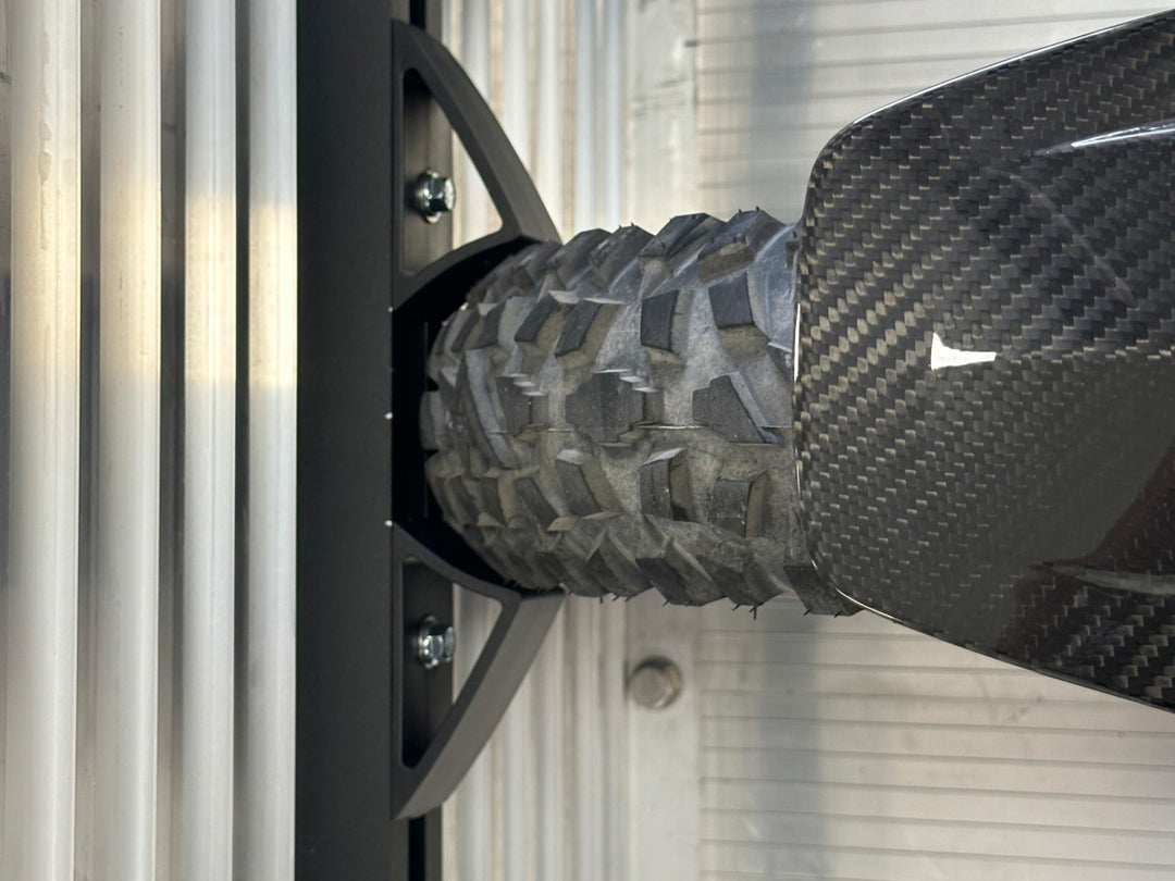 A top down view of a Super 3 front tire held in place by the Hybrid Moto Vise wheel chock.