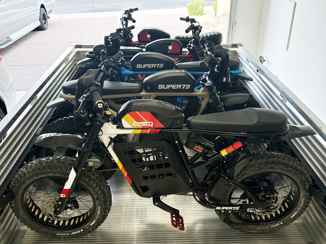 Five Super 73 ebike motorcycles tied down in a utility trailer with a complete Hybrid Moto Rack system.