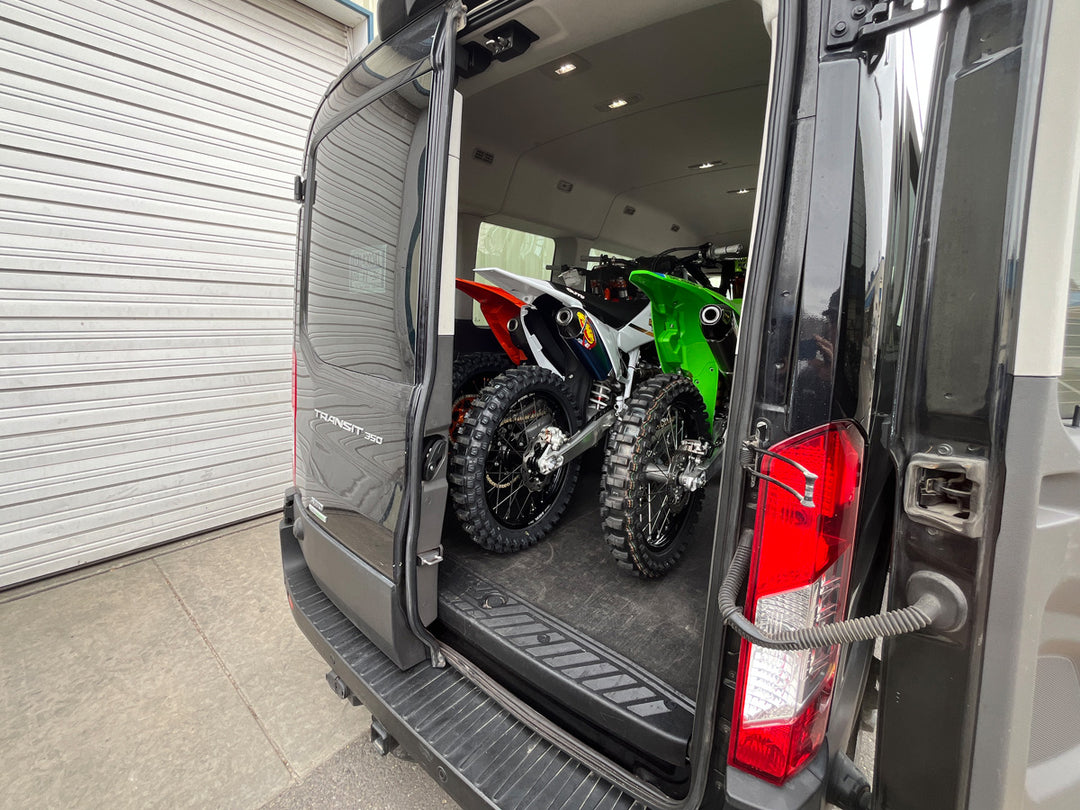 CCR Sport Hybrid Moto Rack System carrying two motocross bikes inside a Ford Transit van with full passenger seating retained.
