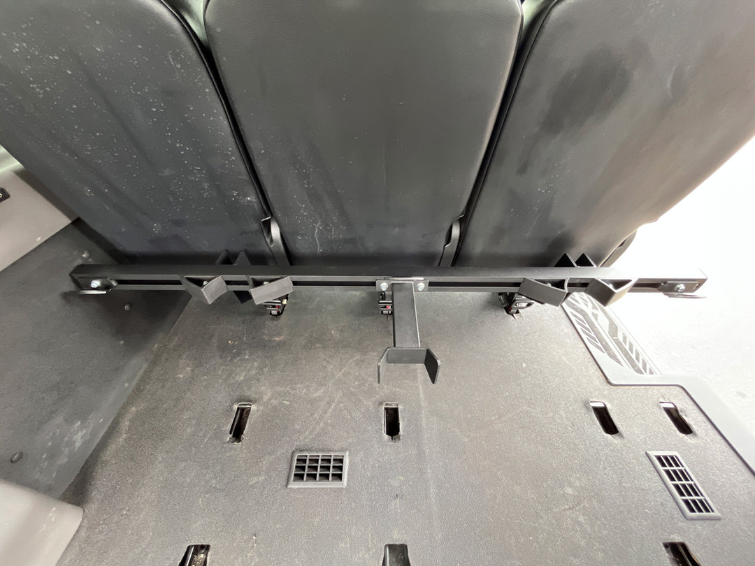 CCR Sport Hybrid Moto Rack System mounted behind passenger seating in a Ford Transit van.