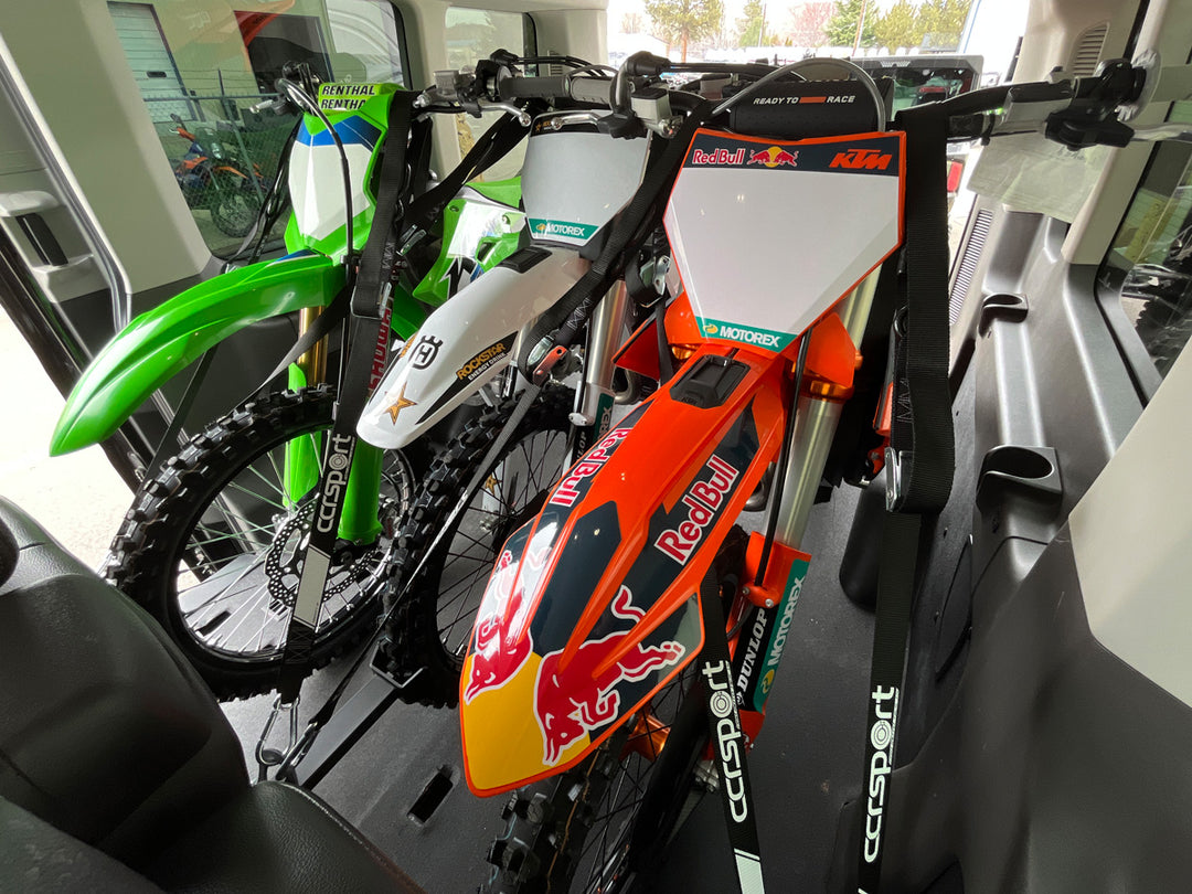 Three off-road motorcycles secured inside a Ford Transit van using a CCR Sport motorcycle transport system.