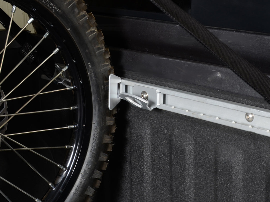 I tight shot of a dirt bike tire secured to the Nissan Utili-track motorcycle wheel chock.