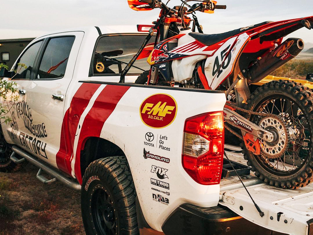 FMF Racing Toyota Tundra with a Red Bull KTM off road motorcycle secured in the truck bed.